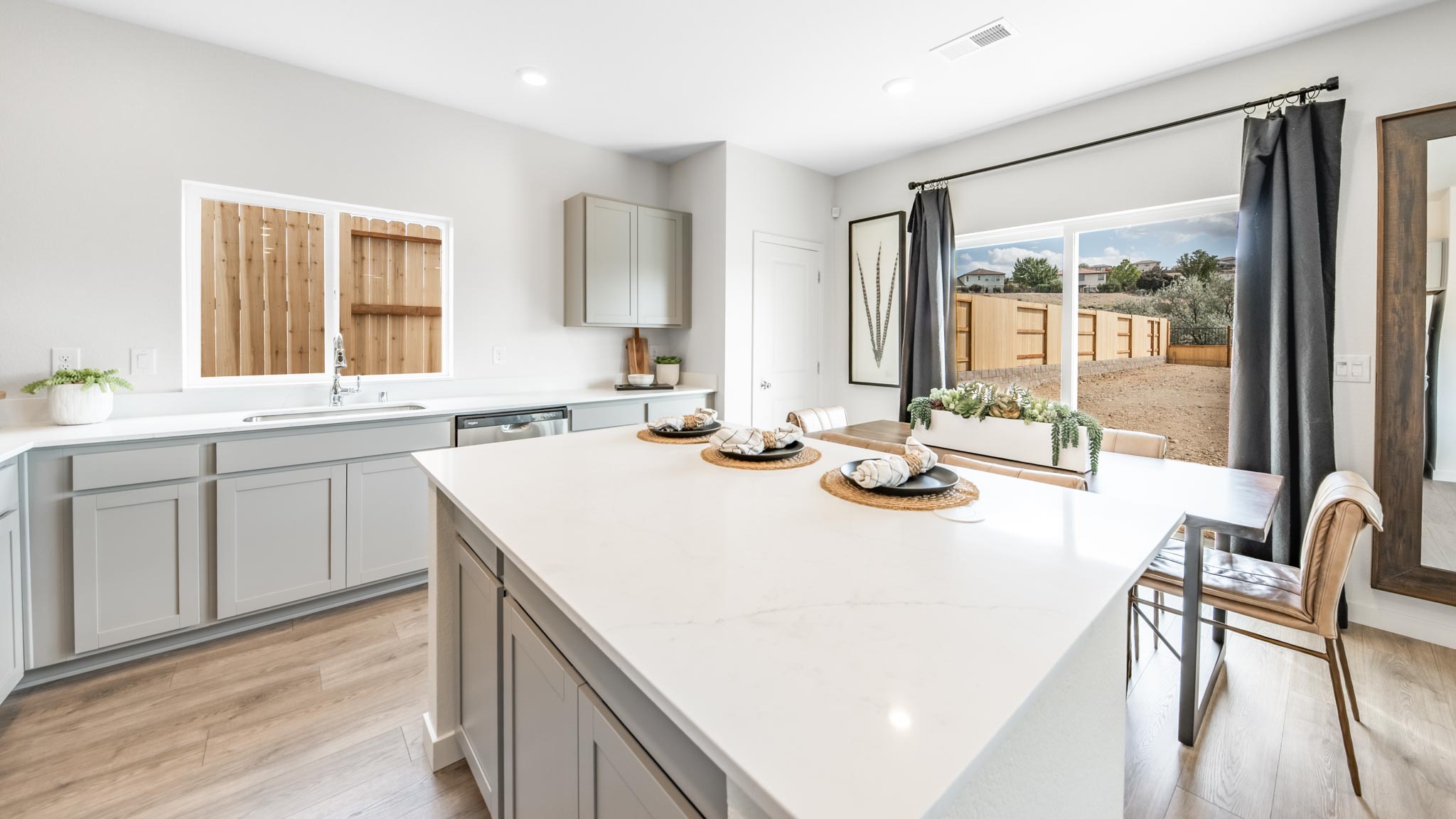 Kitchen island with a dining table and sliding backyard door