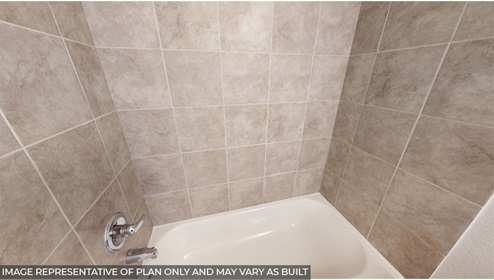 bathroom with bath surround tile