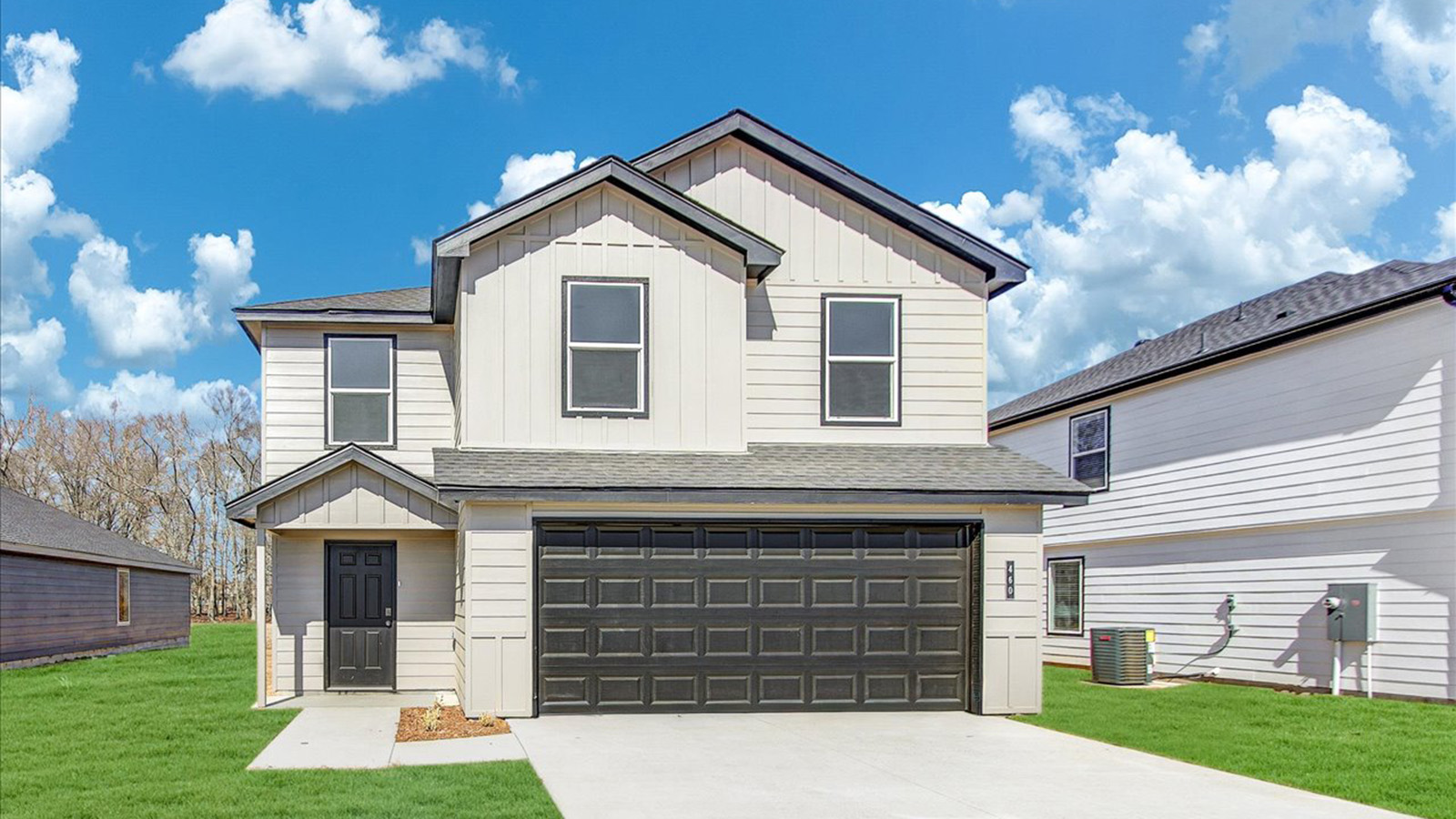 Two story home with white exterior and two car garage