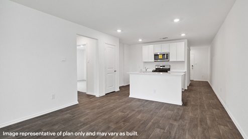 Kitchen with island open to living area
