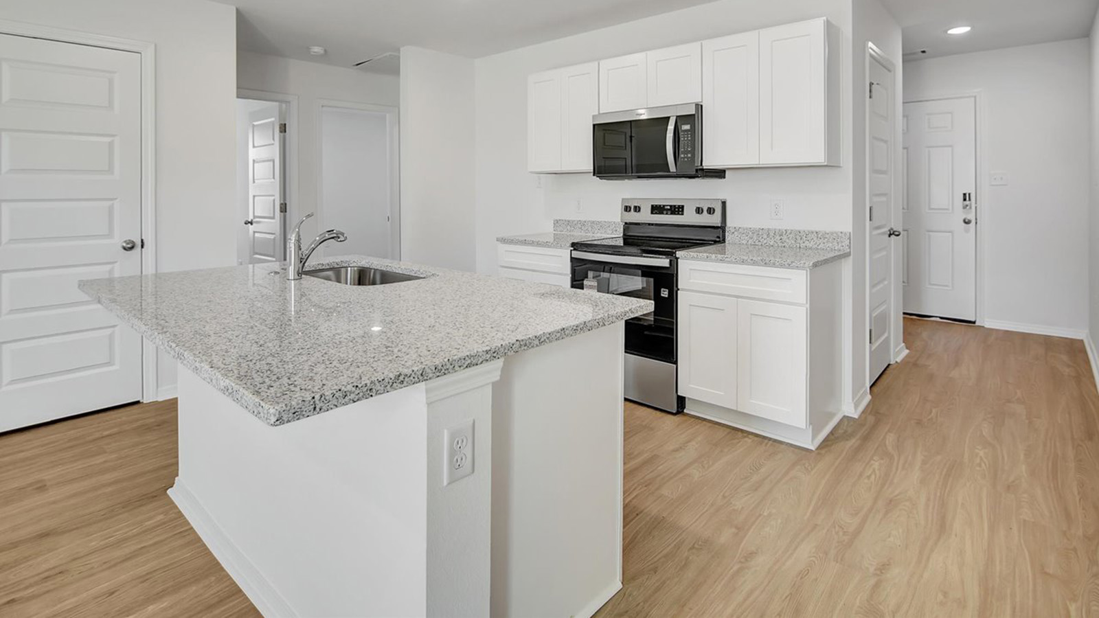 Kitchen with island and white cabinets