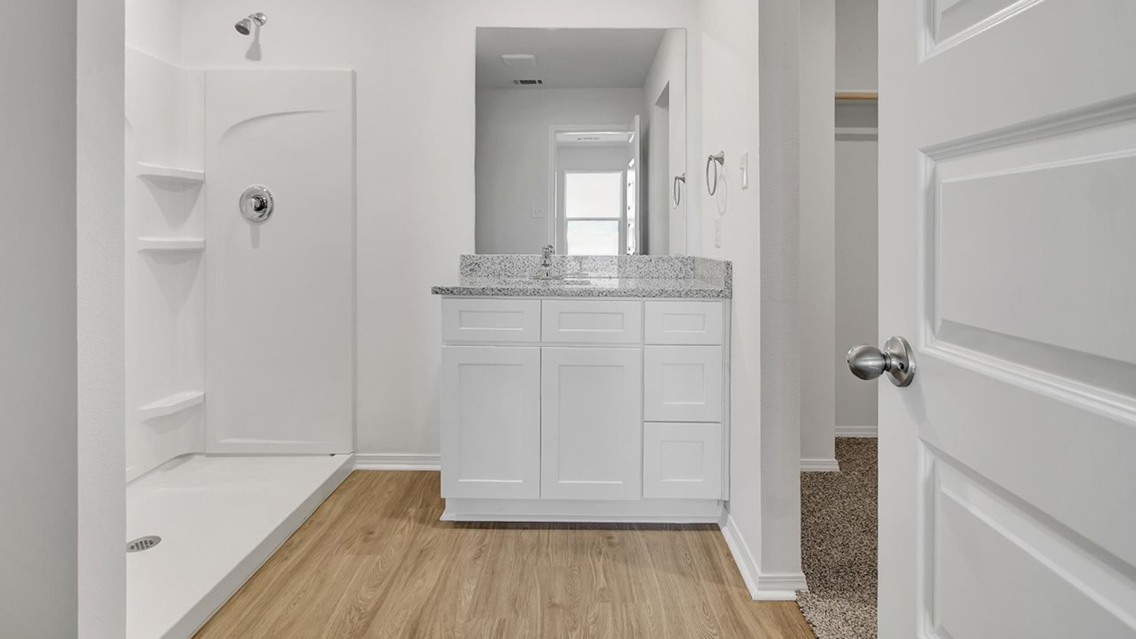 Primary bathroom with white vanity and shower