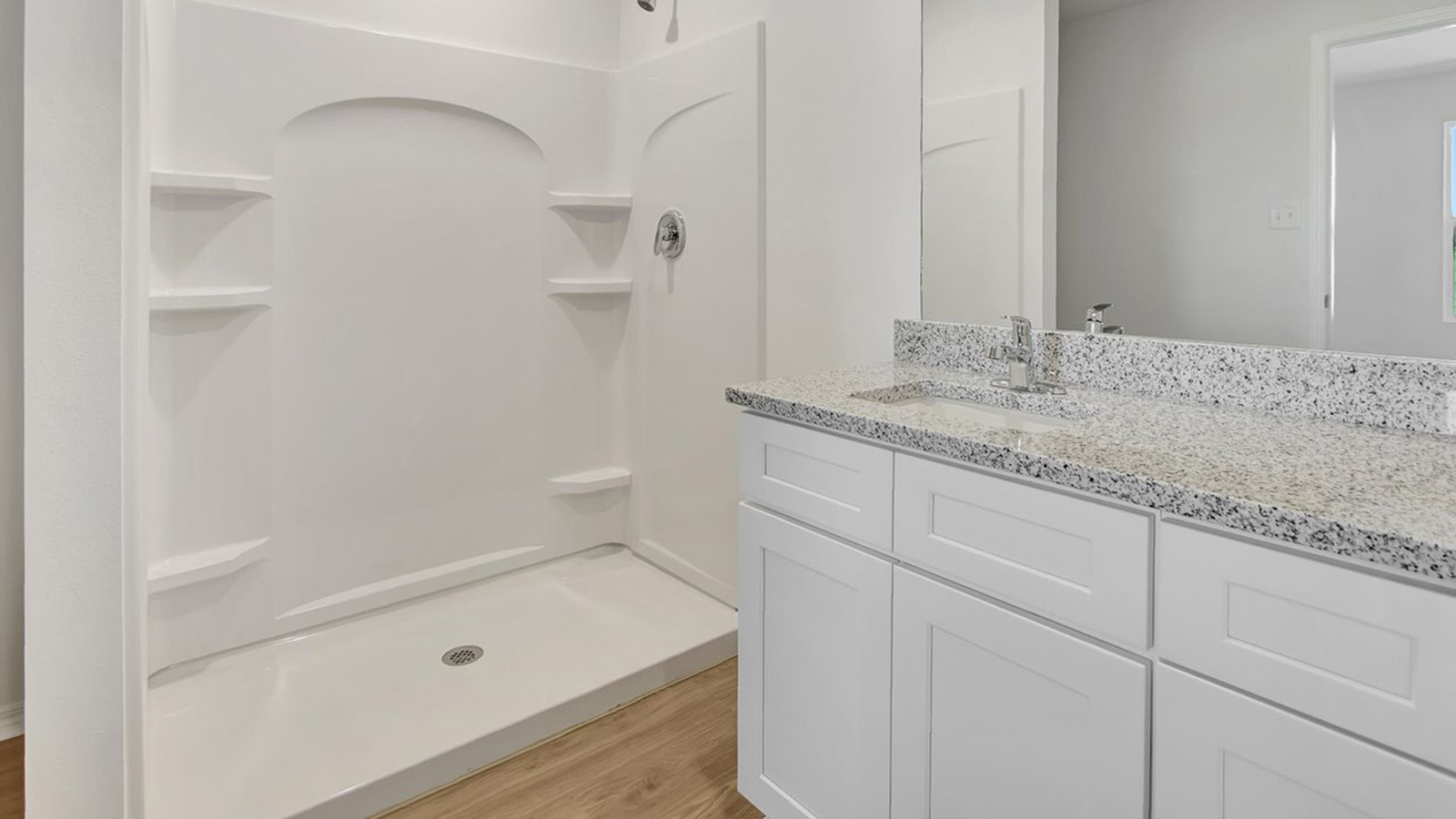 Primary bathroom with white vanity and shower