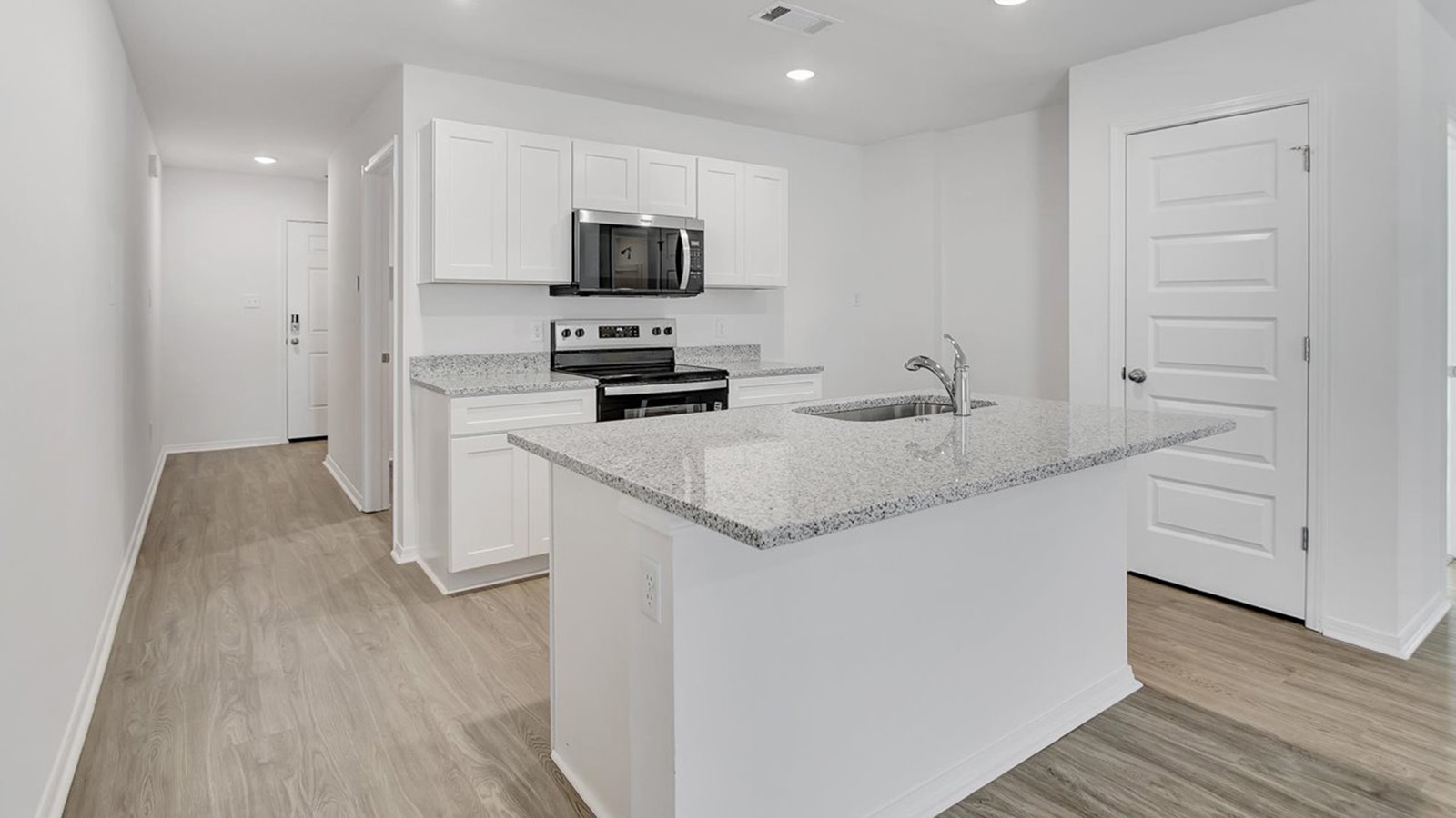 Kitchen with island and white cabinets