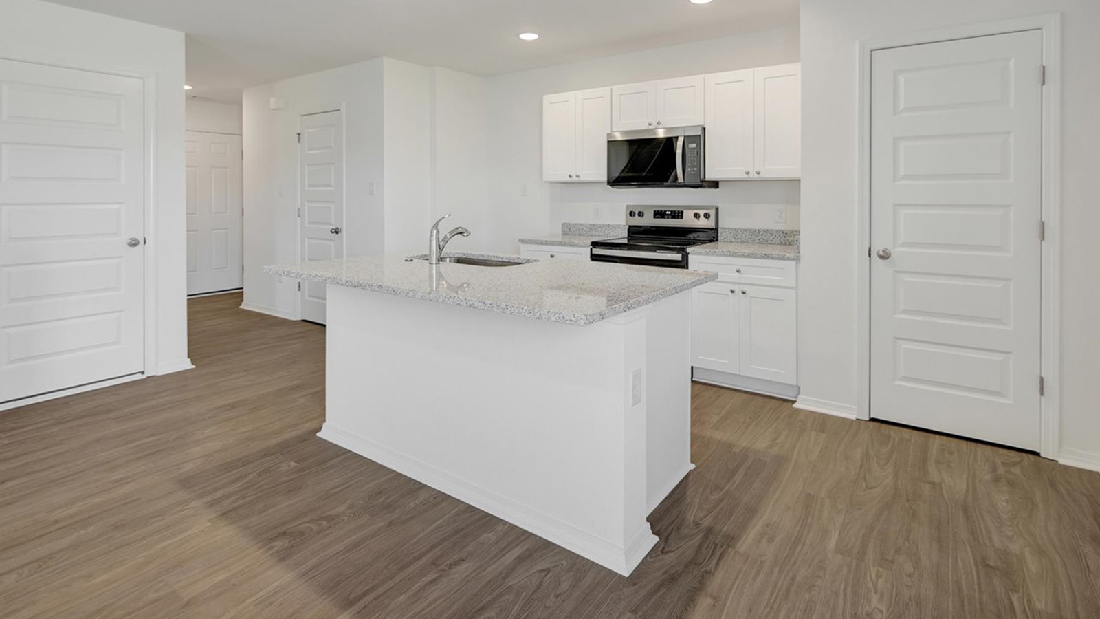 Kitchen with island and white cabinets