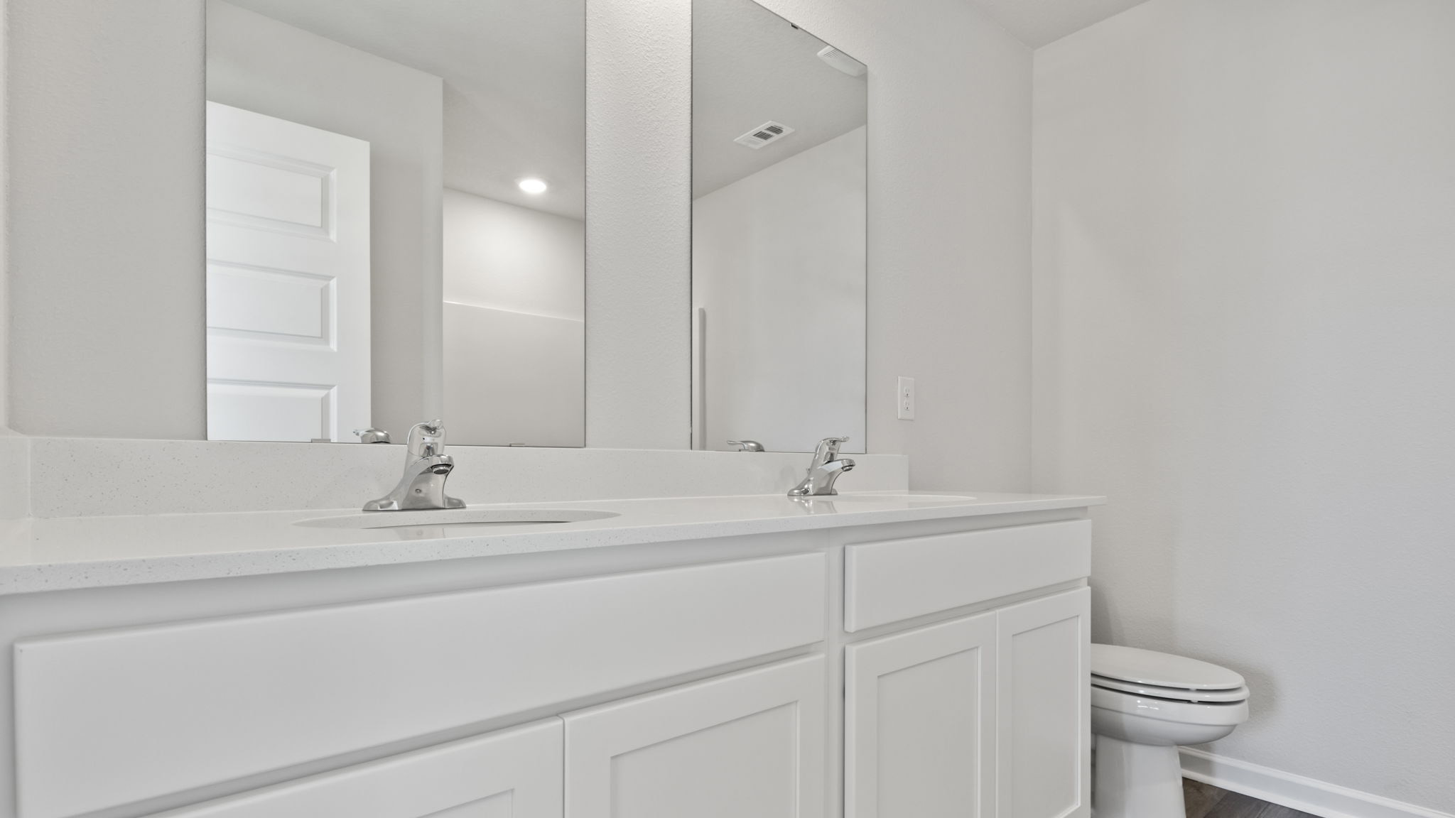 The Lismore Floorplan primary bathroom with dual vanity and quartz countertops