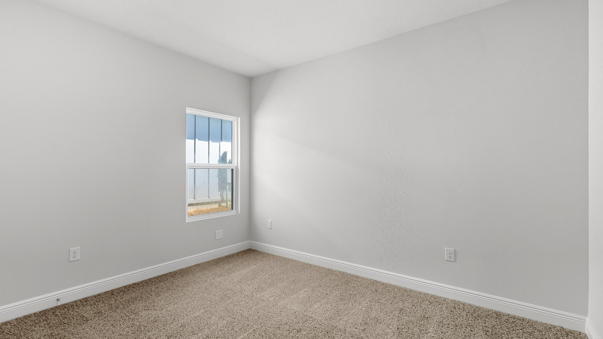The Creekside floorplan guest bedroom two with carpet throughout