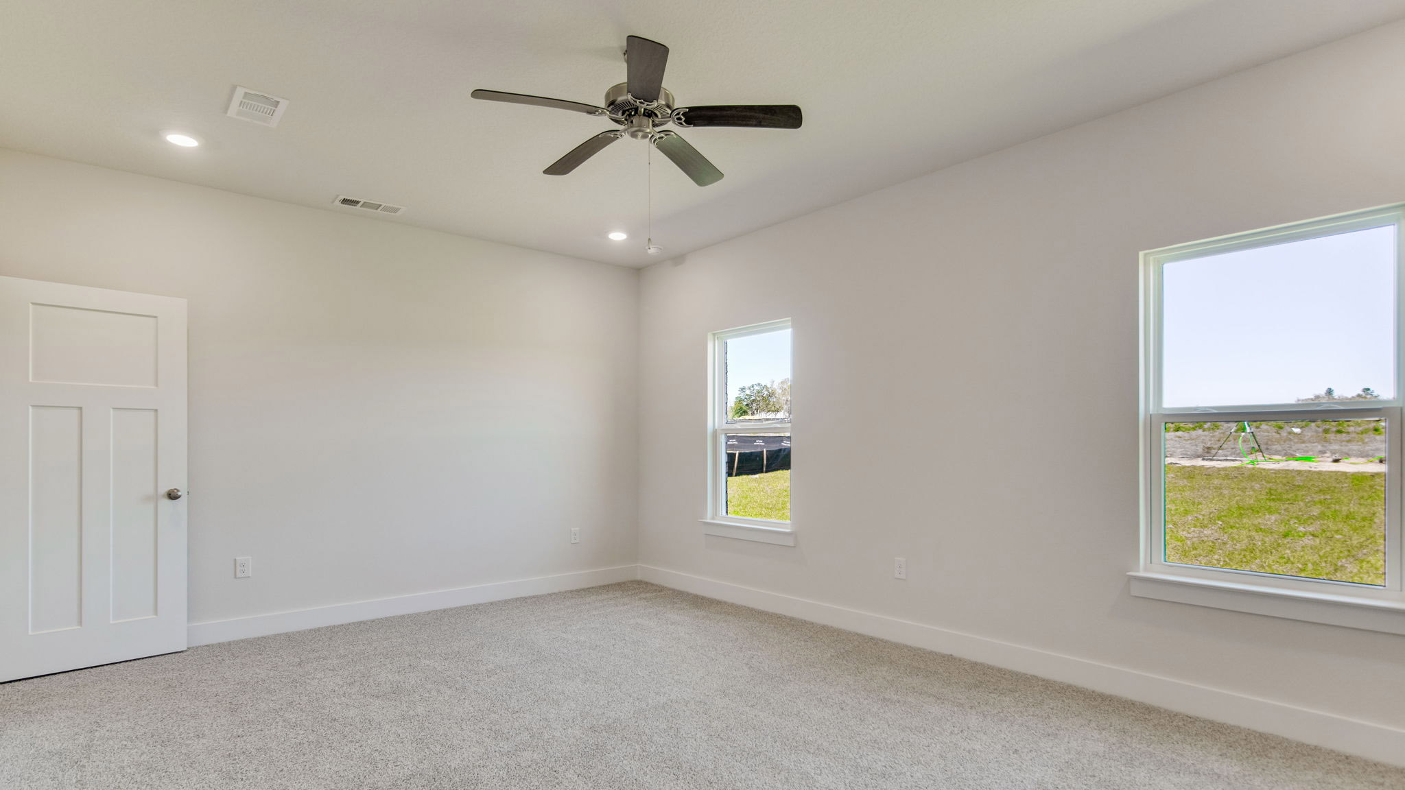 The Ozark floorplan primary bedroom with carpet flooring