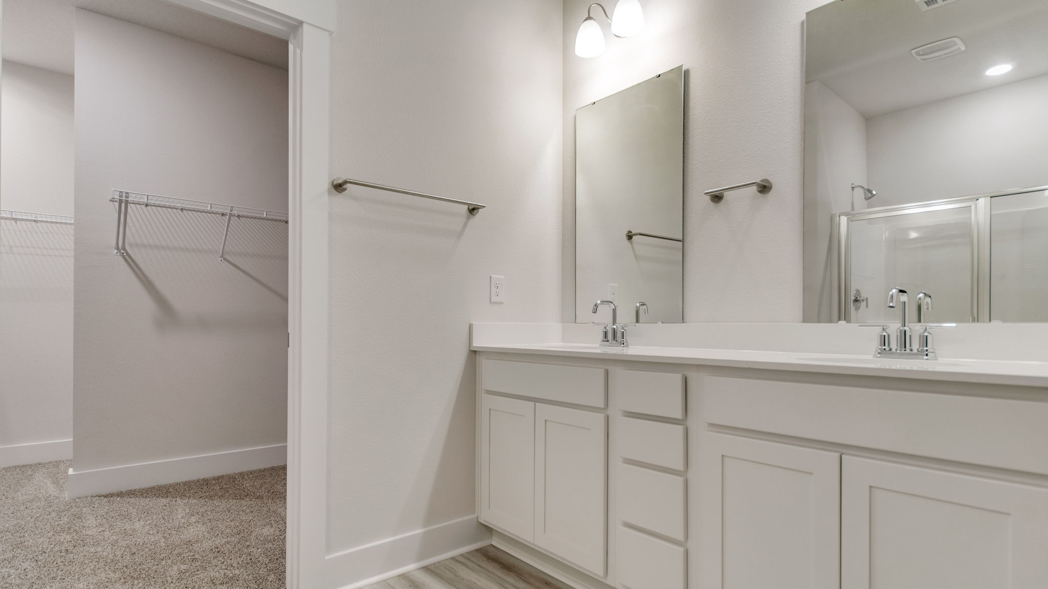 The Ozark floorplan primary bathroom with dual vanity and quartz countertops