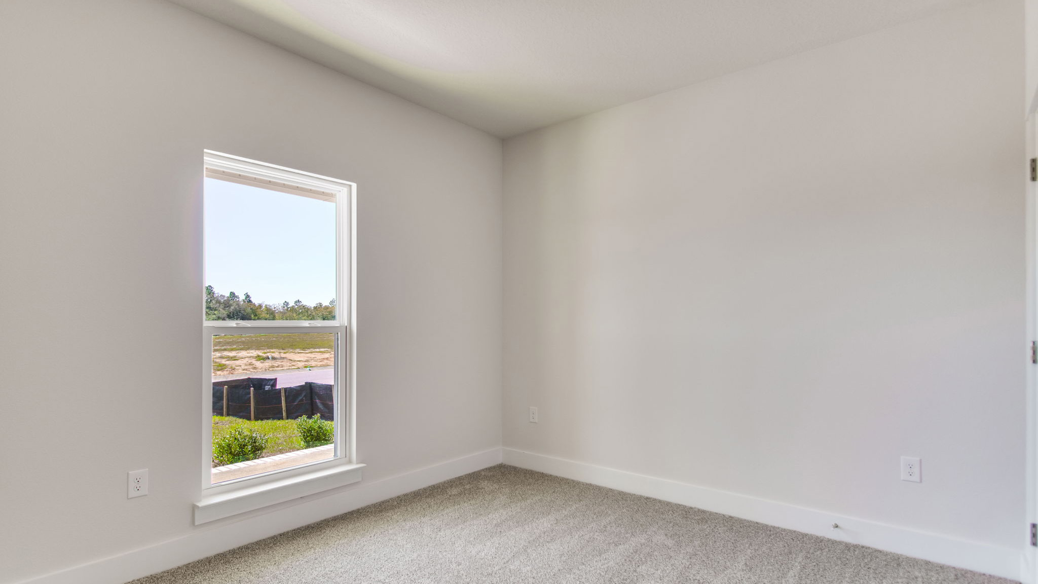 The Ozark floorplan additional bedroom with carpet throughout