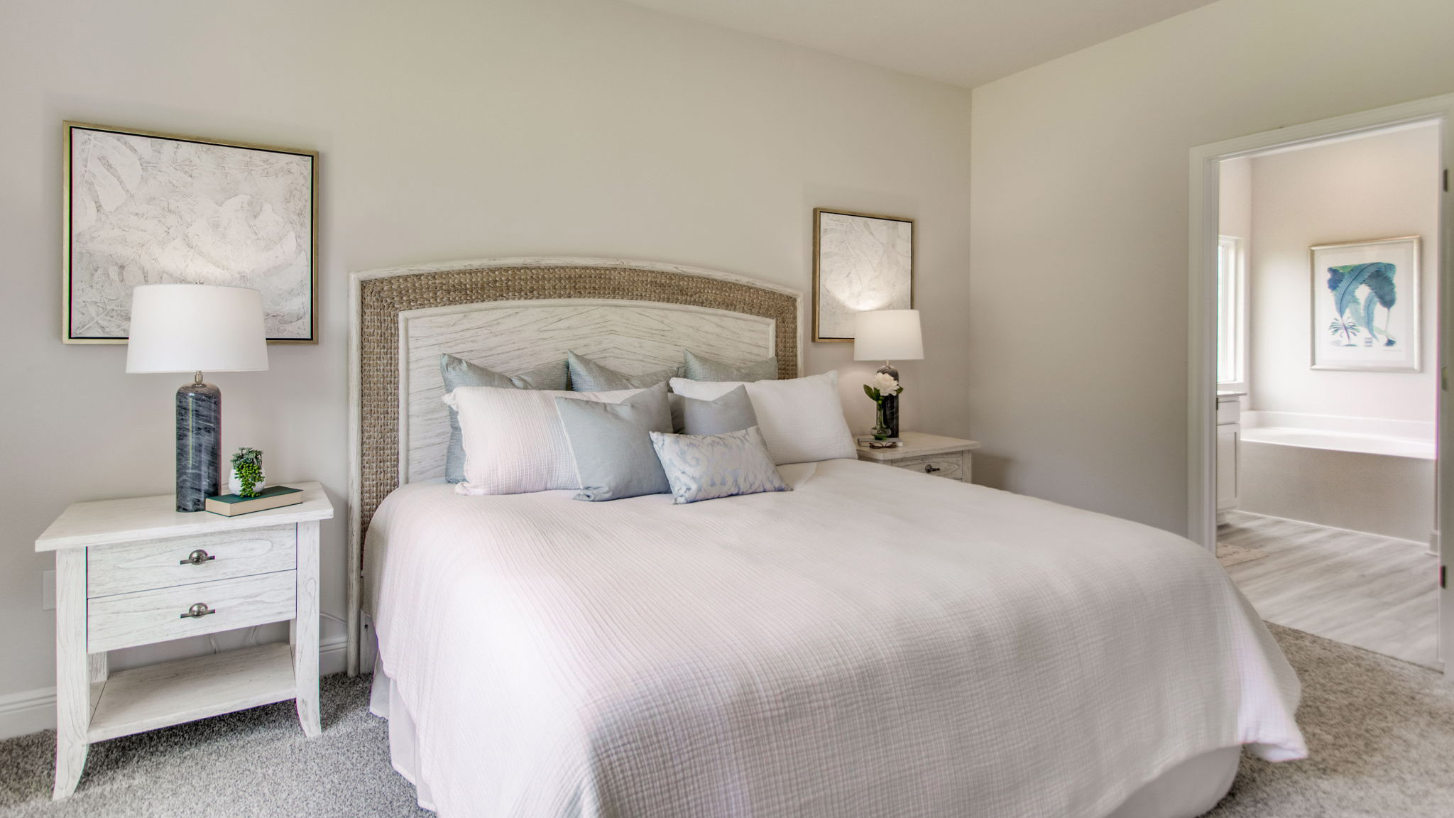 The Beau floorplan primary bedroom with view of primary bathroom entrance