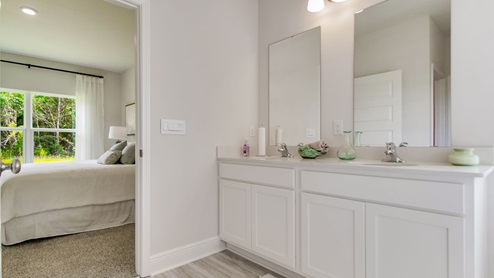 The Beau floorplan primary bathroom with dual vanities and quartz countertops
