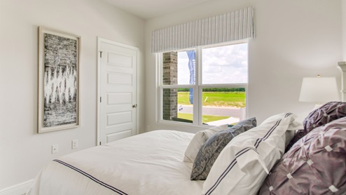 The Beau floorplan guest bedroom one with carpet throughout