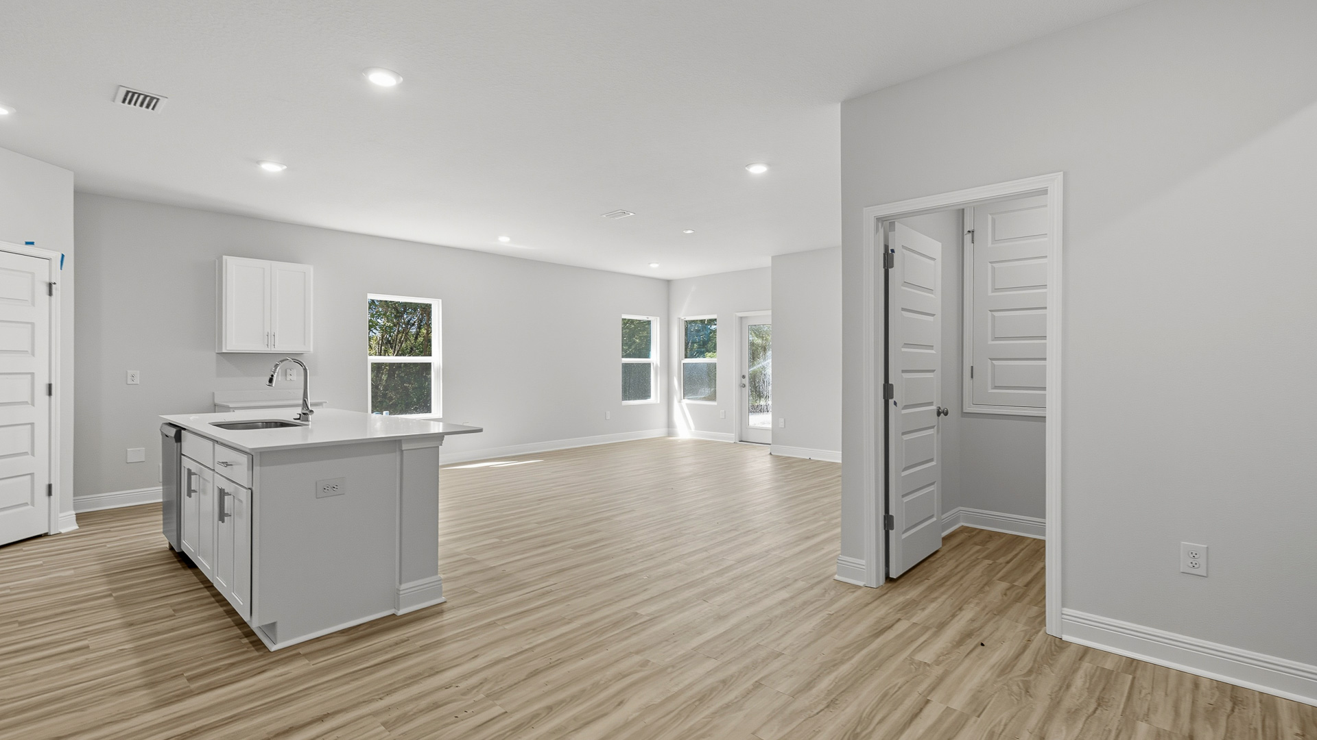 The Creekside floorplan kitchen island with quartz countertops and stainless-steel dishwasher