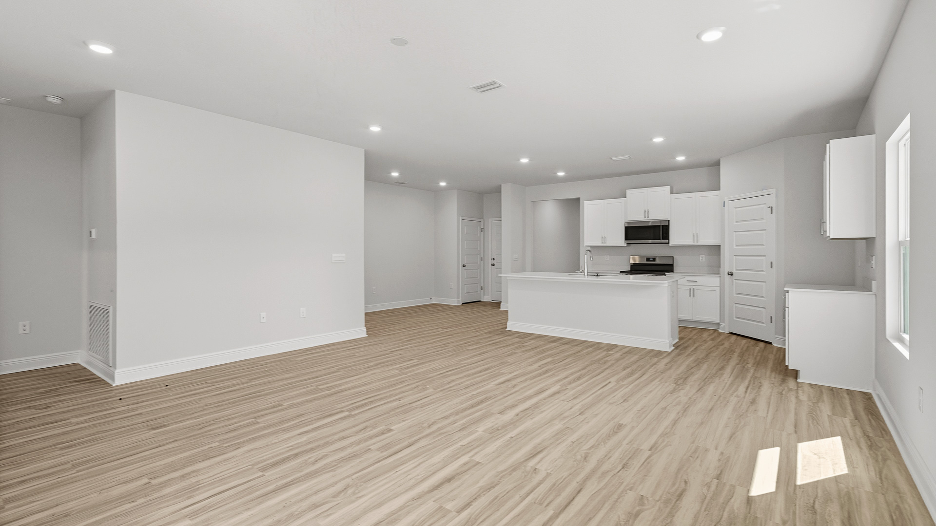 The Creekside floorplan open concept living room with EVP flooring throughout