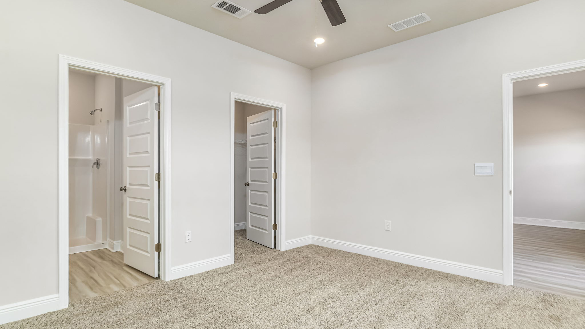 The Delilah primary bedroom with carpet throughout