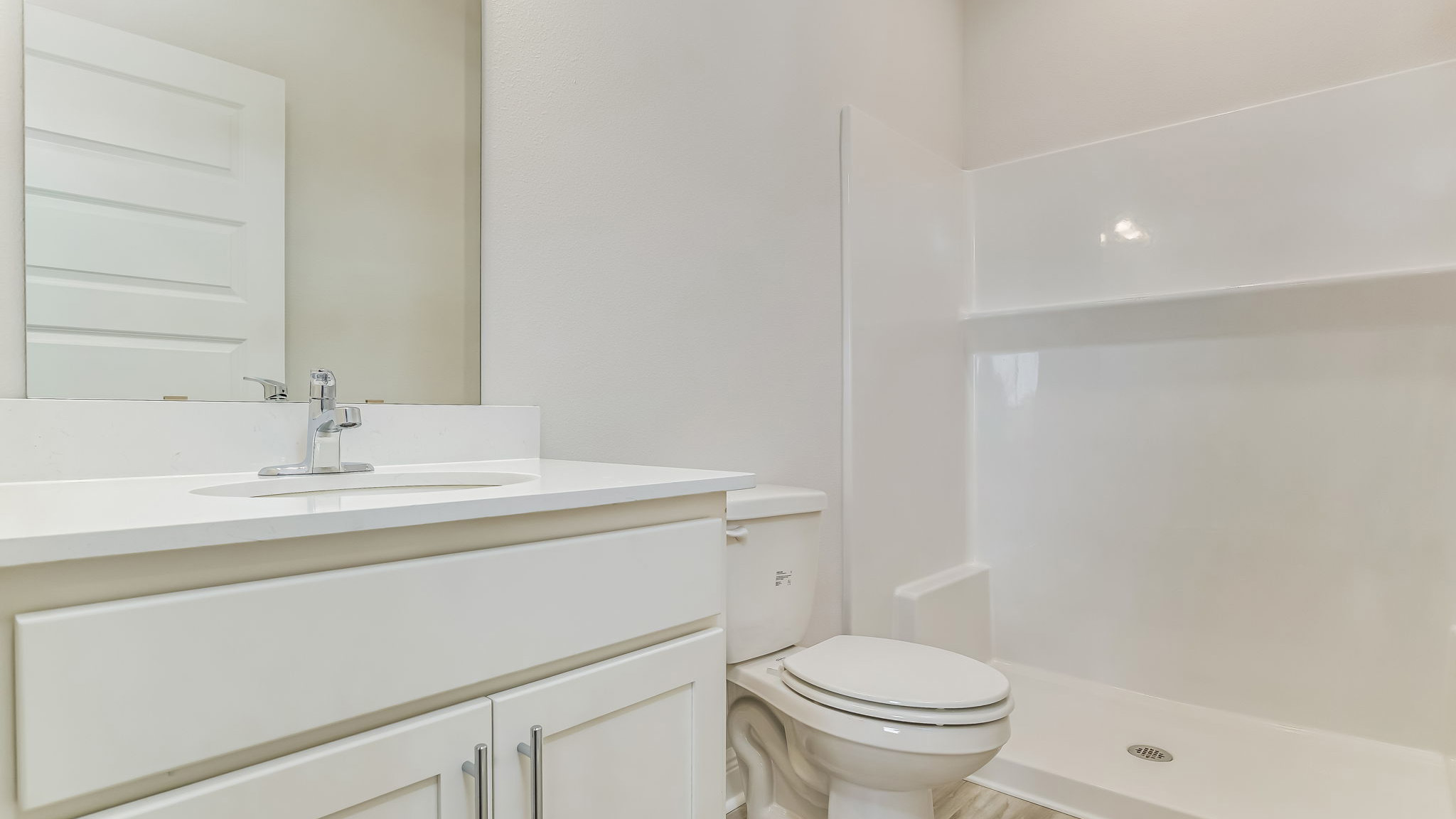 The Delilah primary bathroom with shower and Quartz countertops
