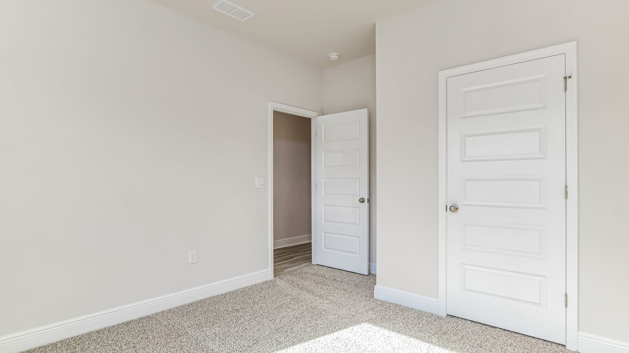 The Delilah guest bedroom two with carpet throughout