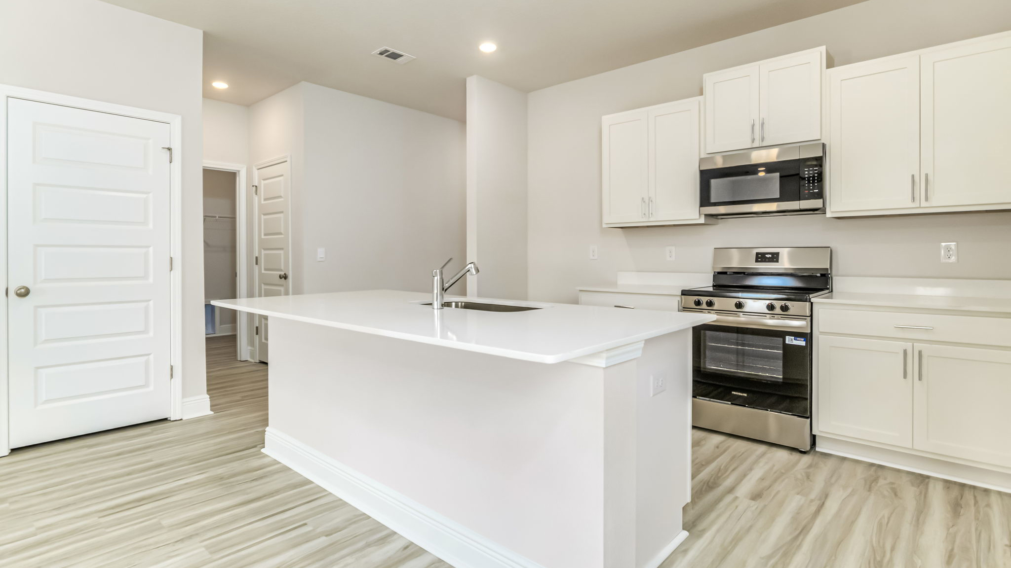 The Delilah open concept living and dining room with EVP flooring throughout