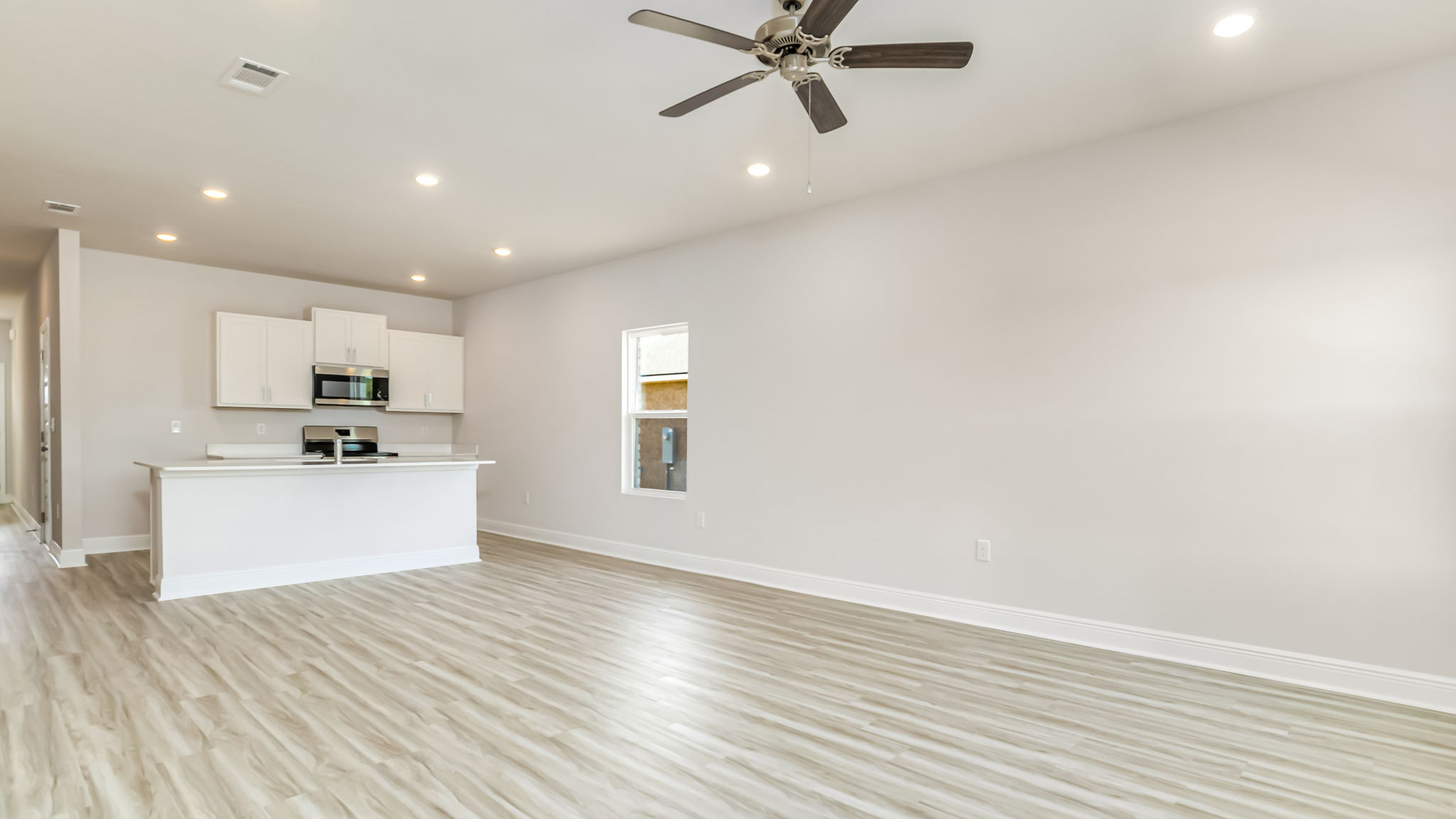 The Delilah open concept living and dining room with EVP flooring throughout