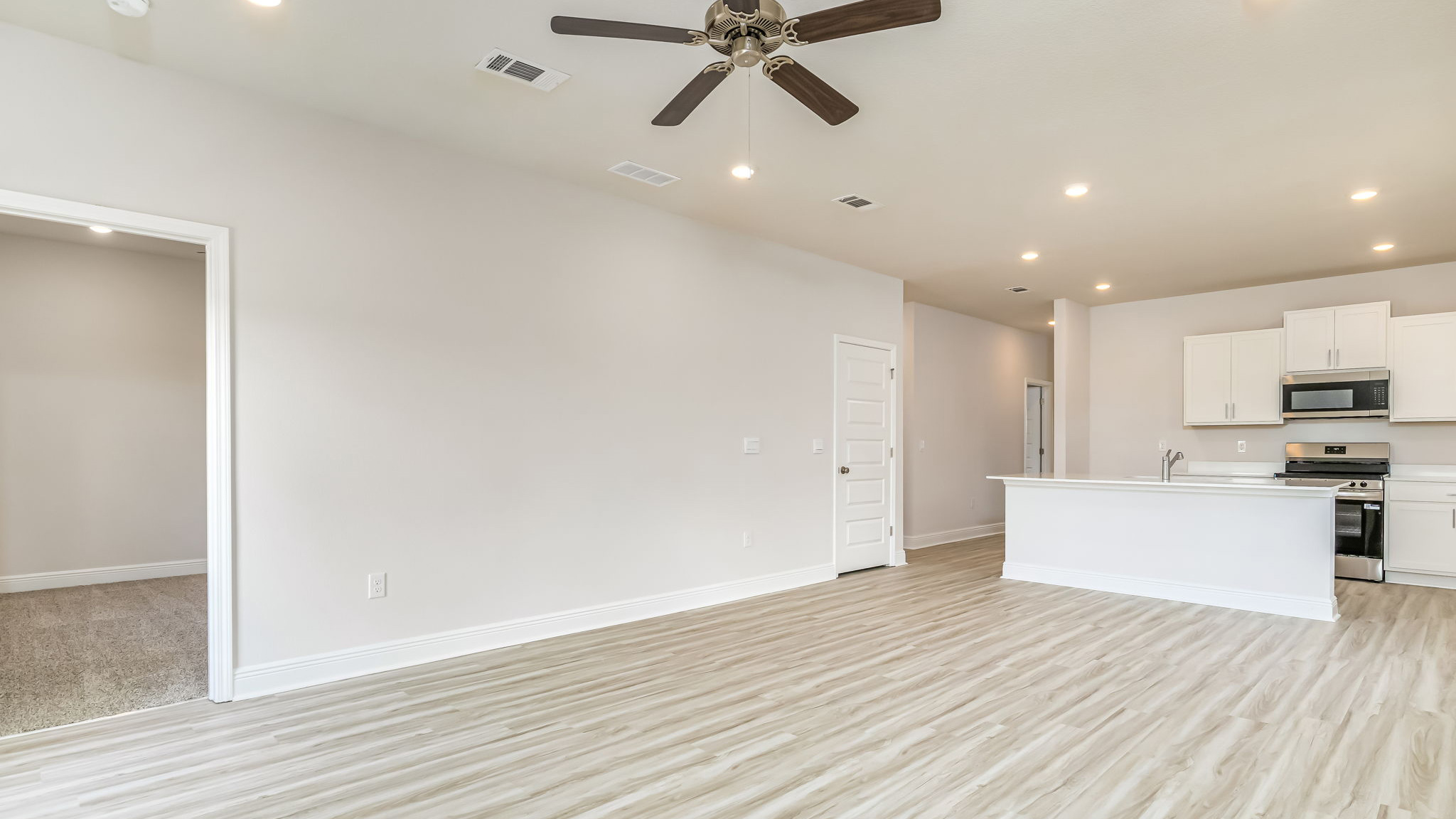 The Delilah open concept living and dining room with EVP flooring throughout