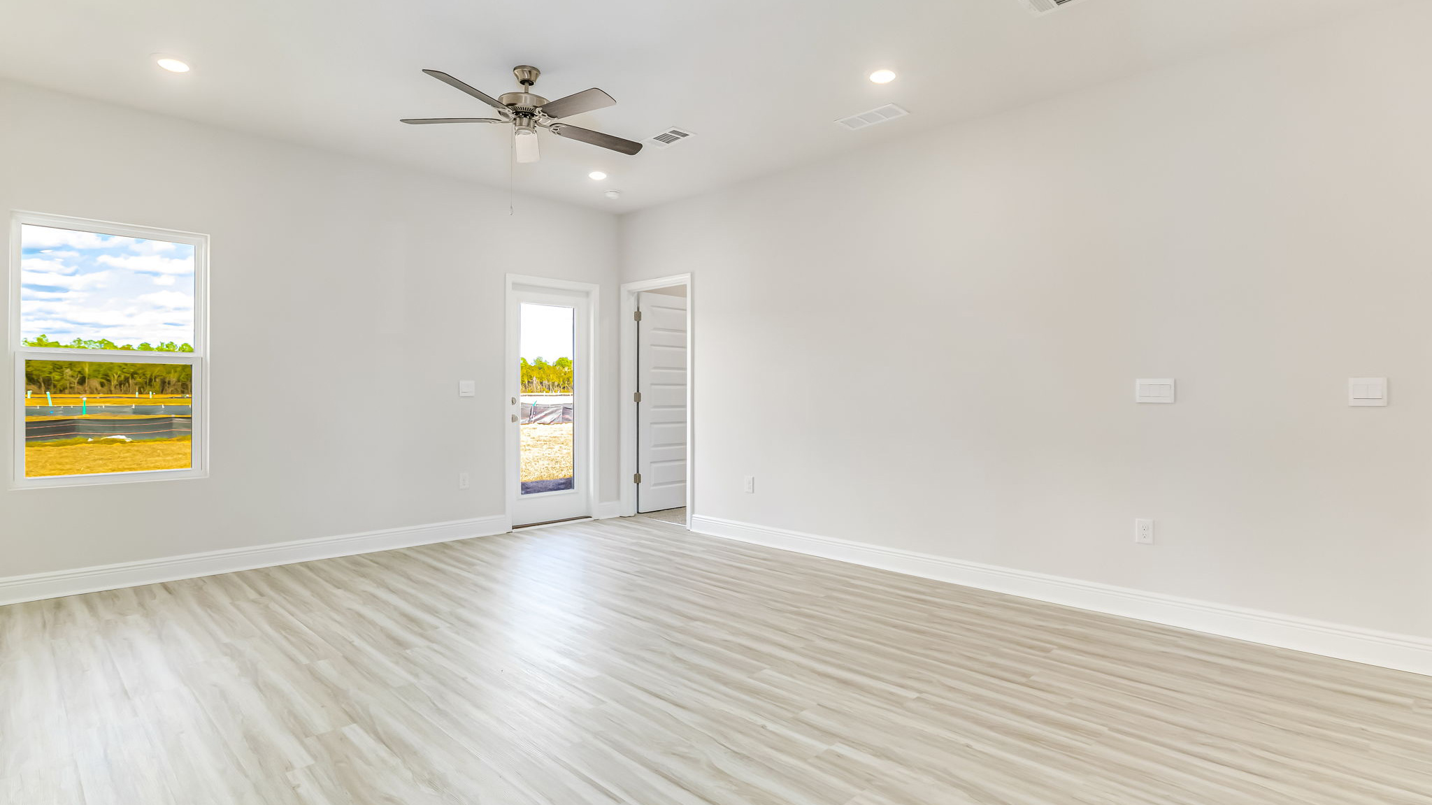 The Delilah open concept living and dining room with EVP flooring throughout