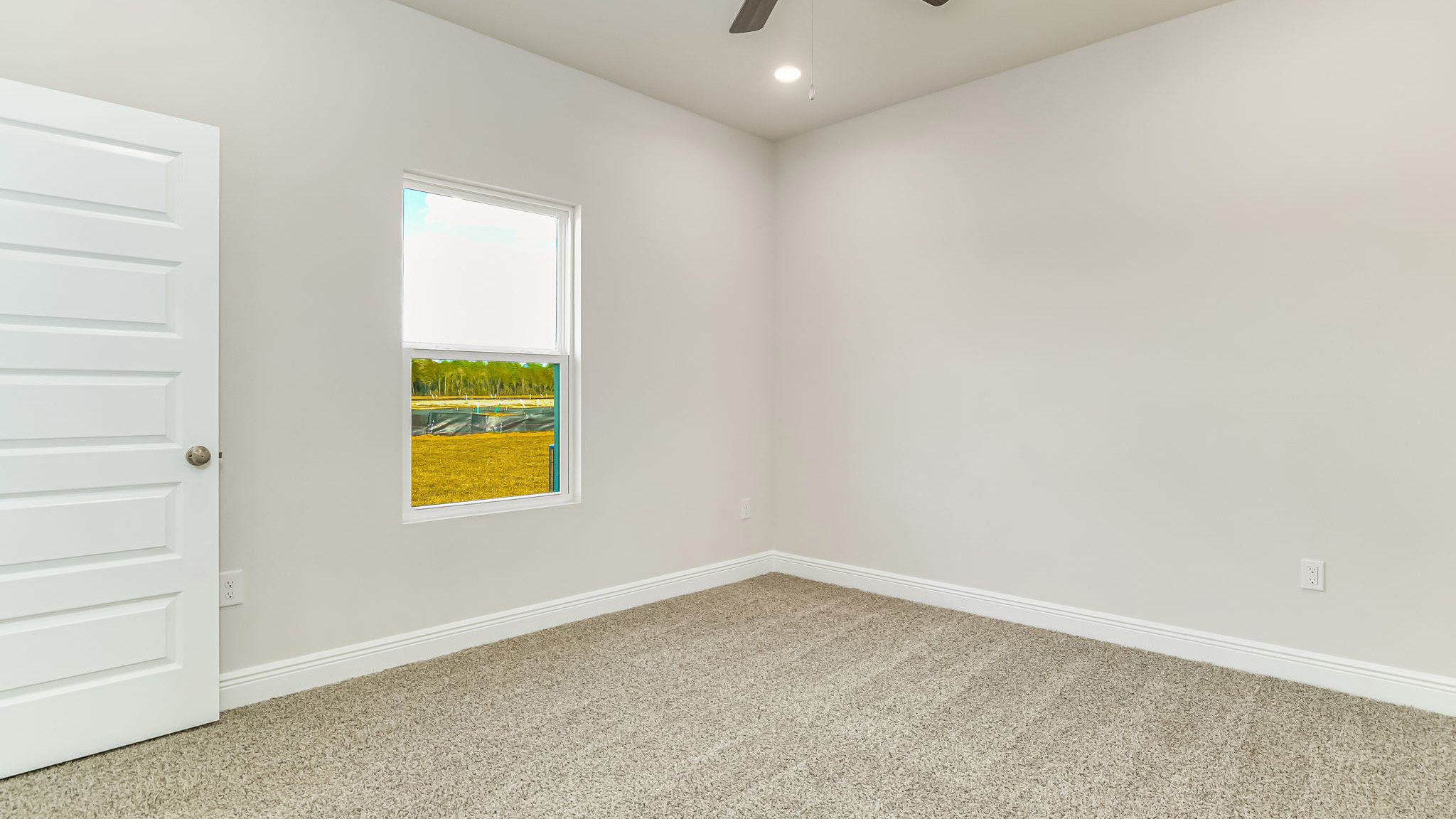 The Delilah primary bedroom with carpet throughout
