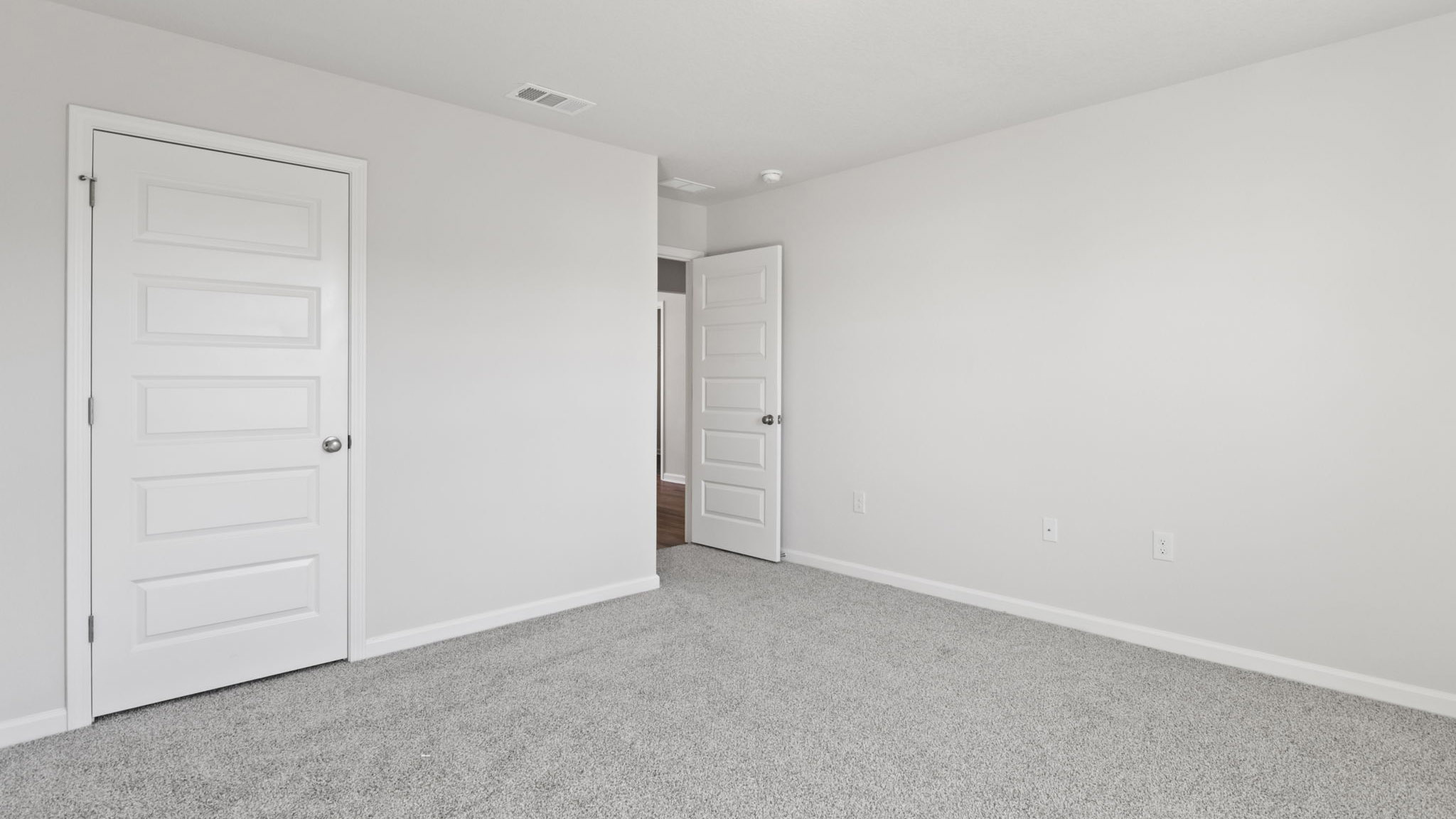 The Walker Floorplan bedroom one with carpet throughout