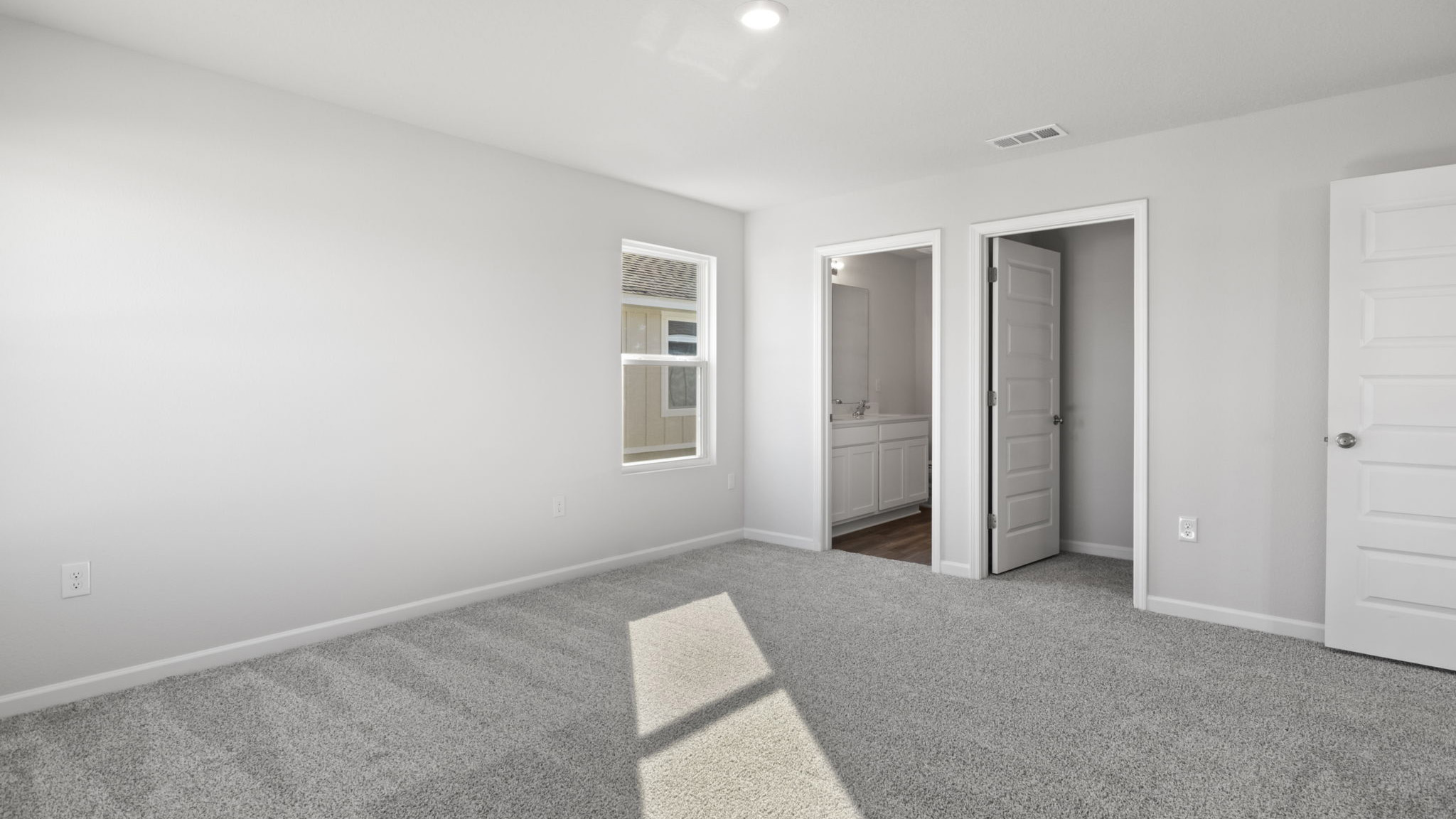 The Walker Floorplan primary bedroom with two windows