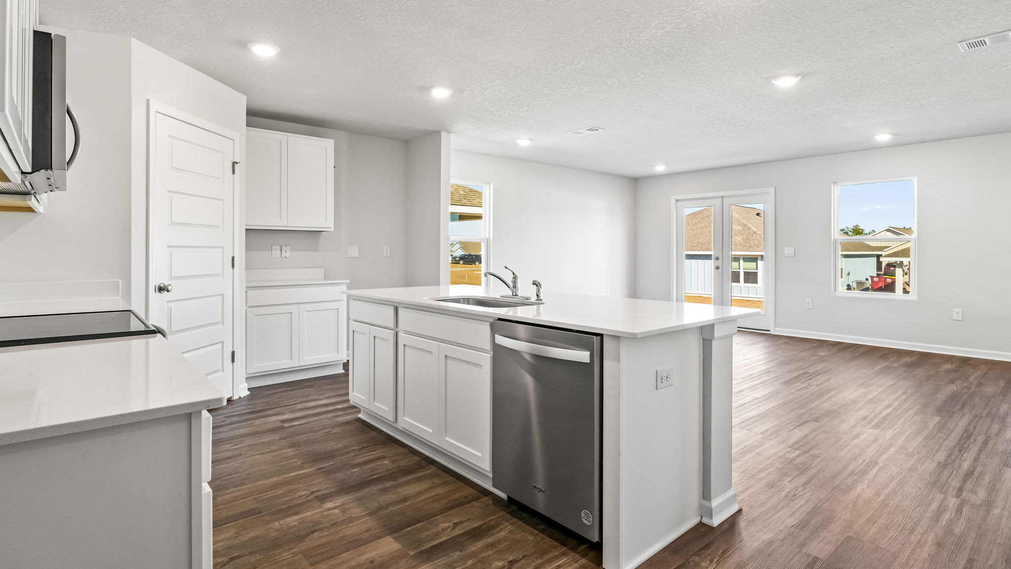 The Walker Floorplan kitchen with white shaker cabinets and quartz countertops