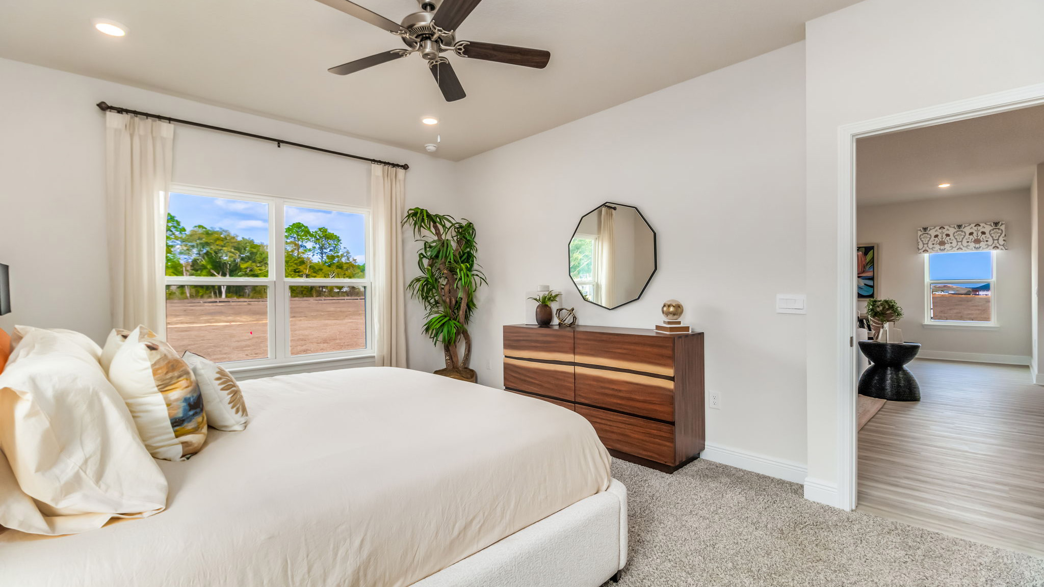 The Belfort floorplan primary bedroom with carpet throughout and 9 foot ceilings