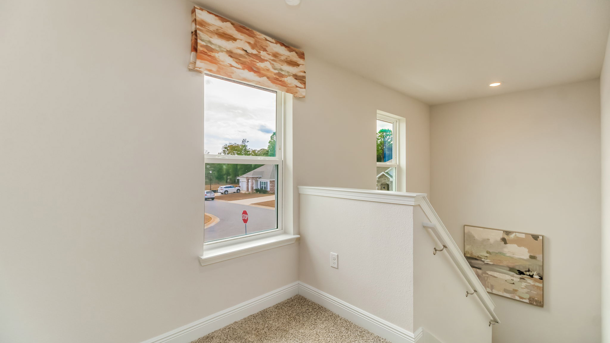 The Belfort floorplan second floor landing space with lots of natural light from two windows