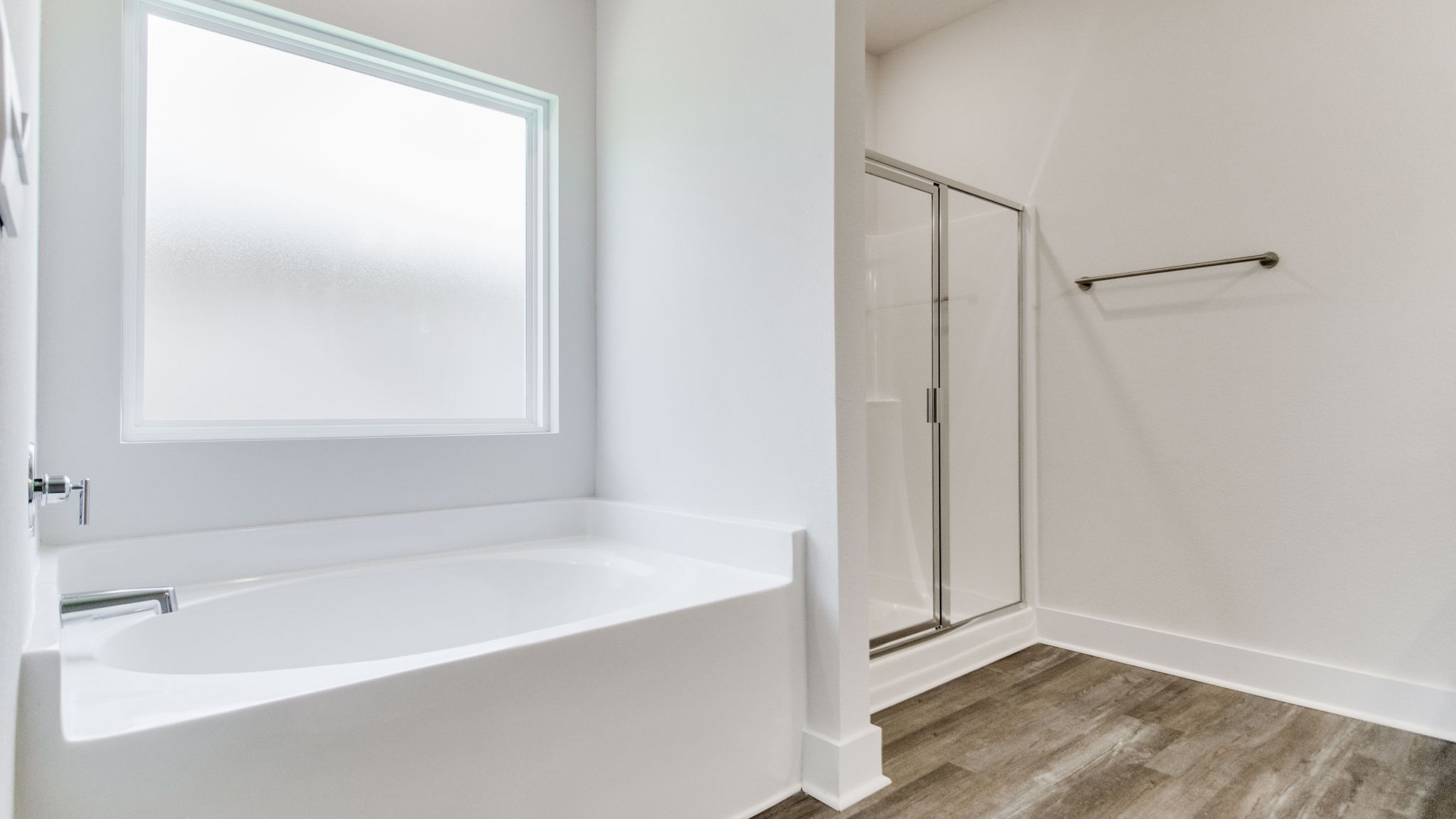 The Lamar floorplan primary bathroom with separate shower and soaking tub
