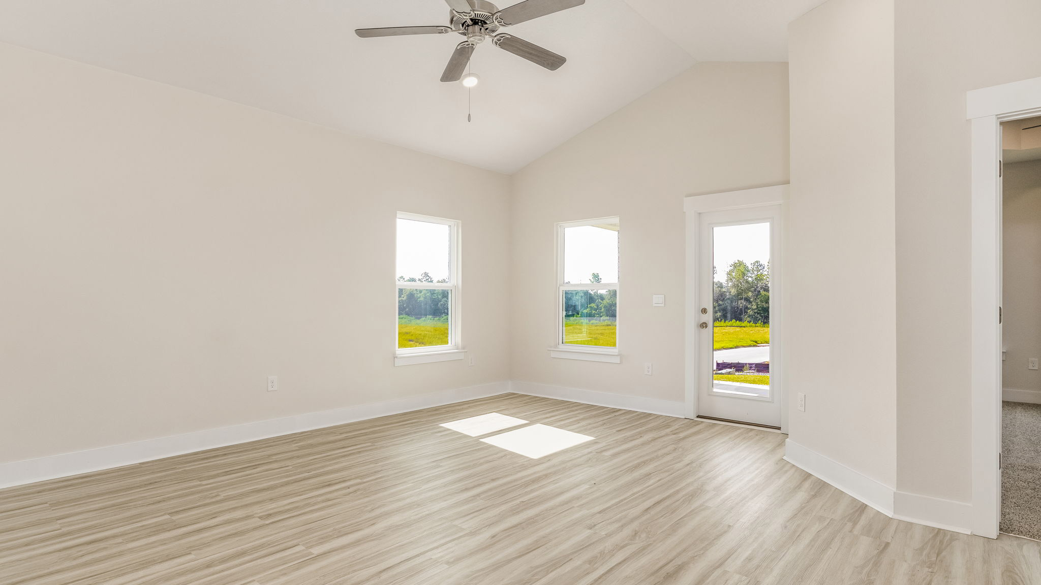 The Oakley floorplan living room with two windows and back porch access