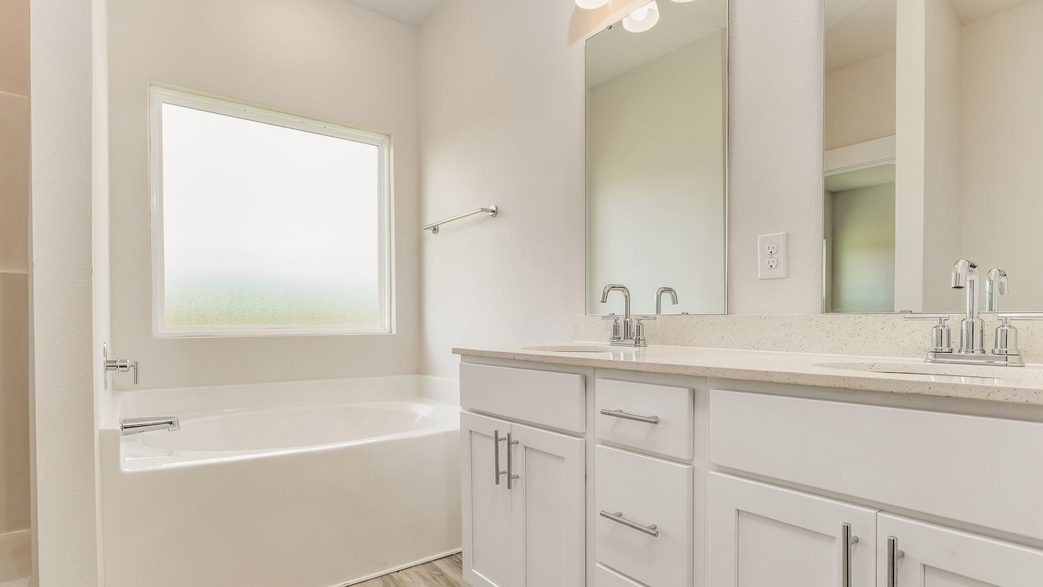 The Oakley floorplan primary bathroom with dual vanities and soaking tub