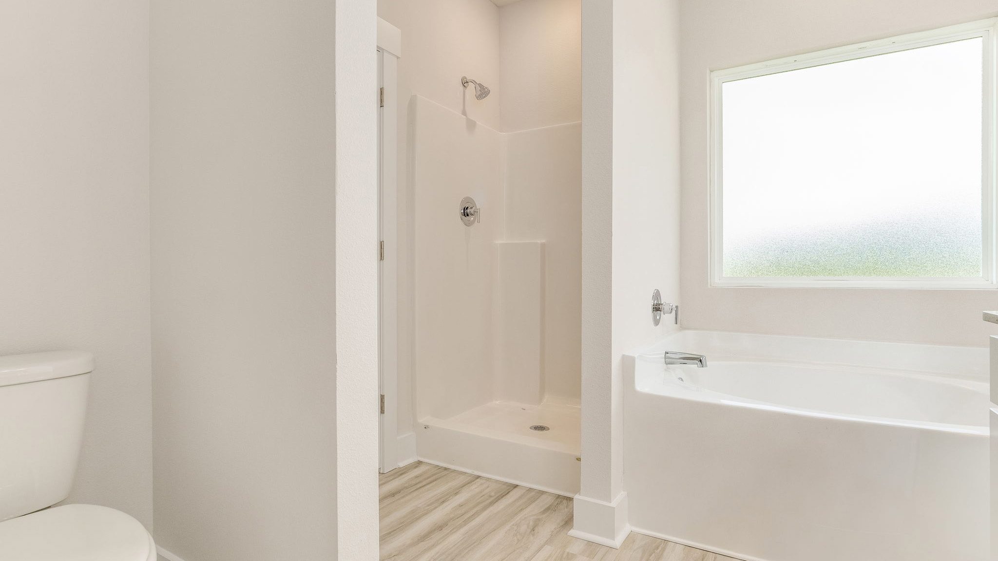 The Oakley floorplan primary bathroom with separate walk-in shower and tub