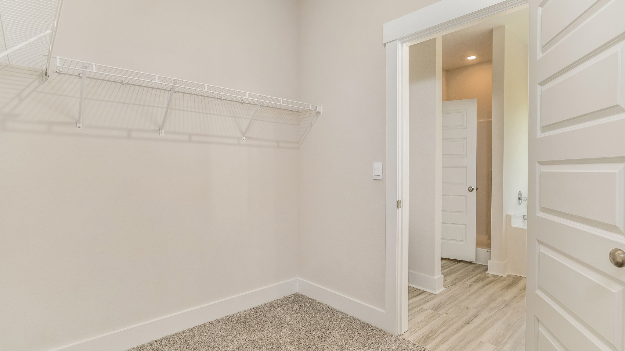 The Oakley floorplan primary bedroom closet with carpet throughout