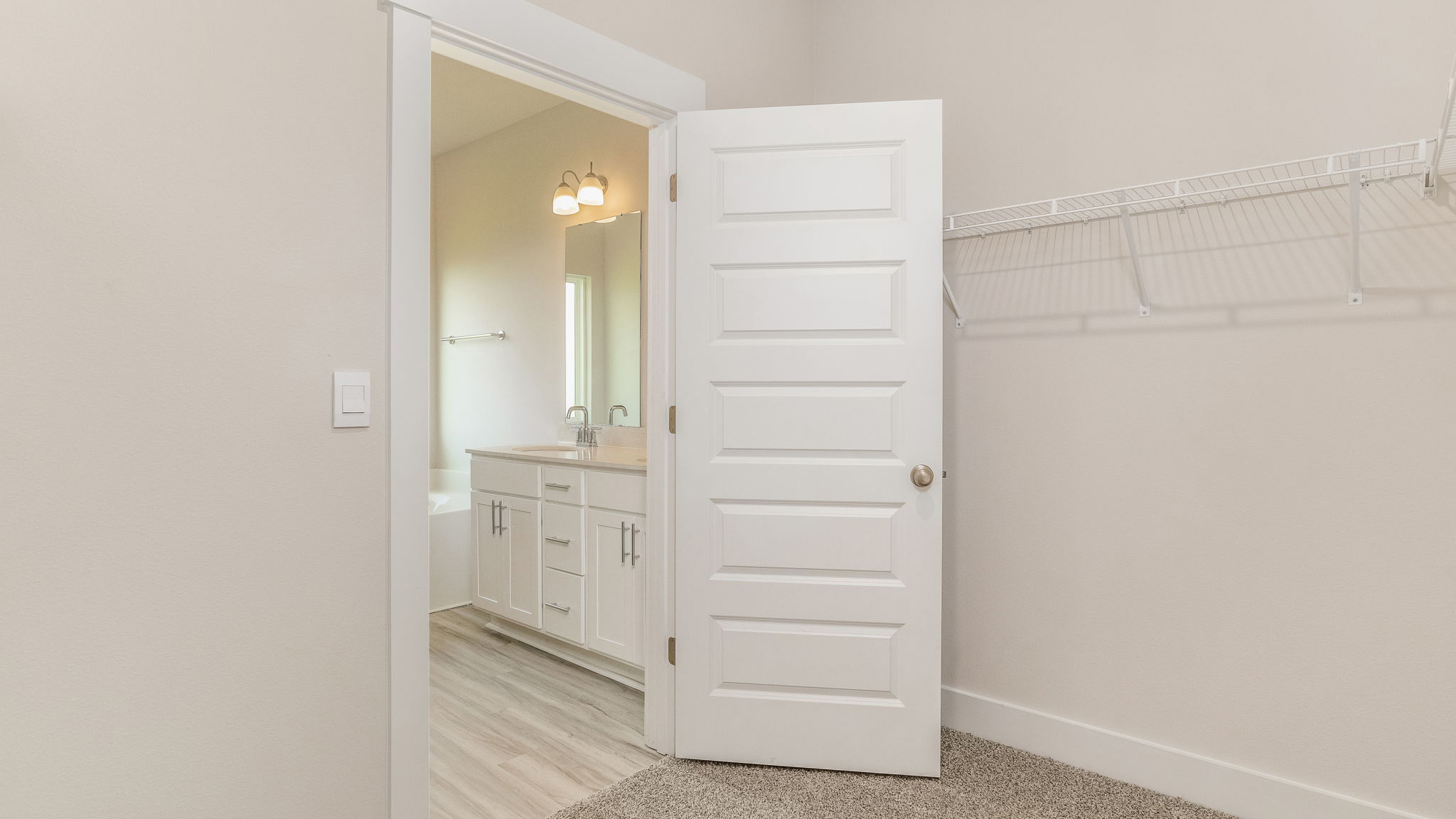 The Oakley floorplan primary bedroom closet with carpet throughout