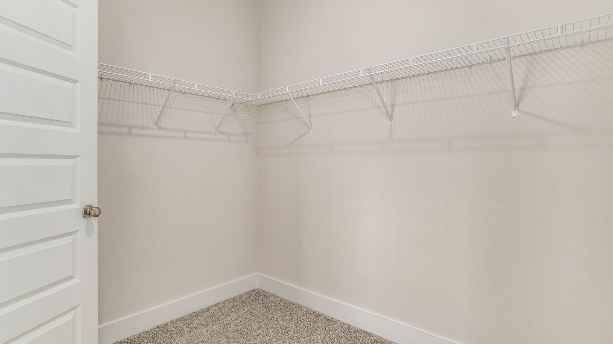 The Oakley floorplan primary bedroom closet with carpet throughout