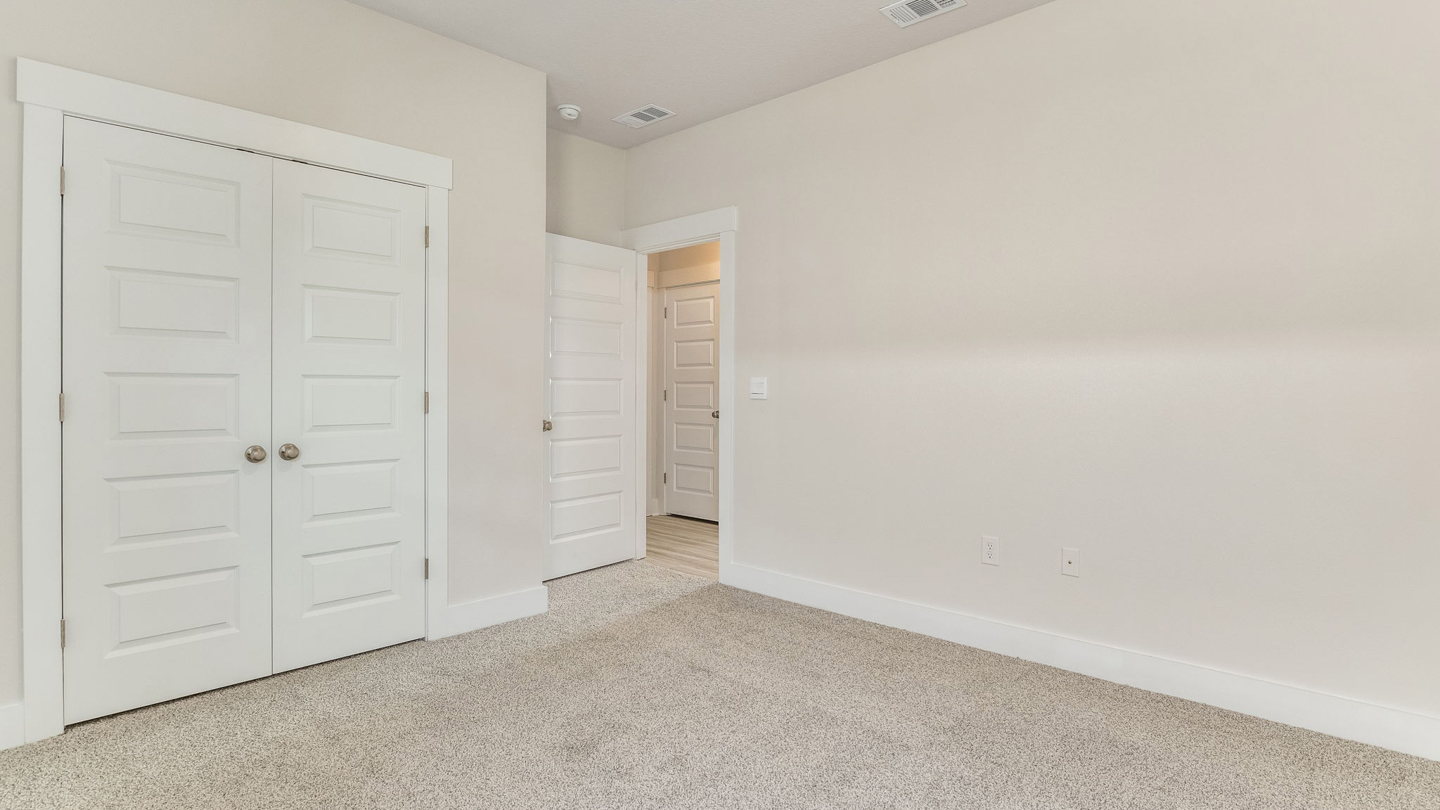 The Oakley floorplan guest bedroom one with carpet throughout