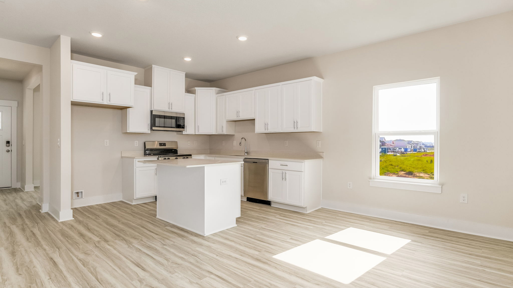 The Oakley floorplan kitchen with LVP flooring throughout