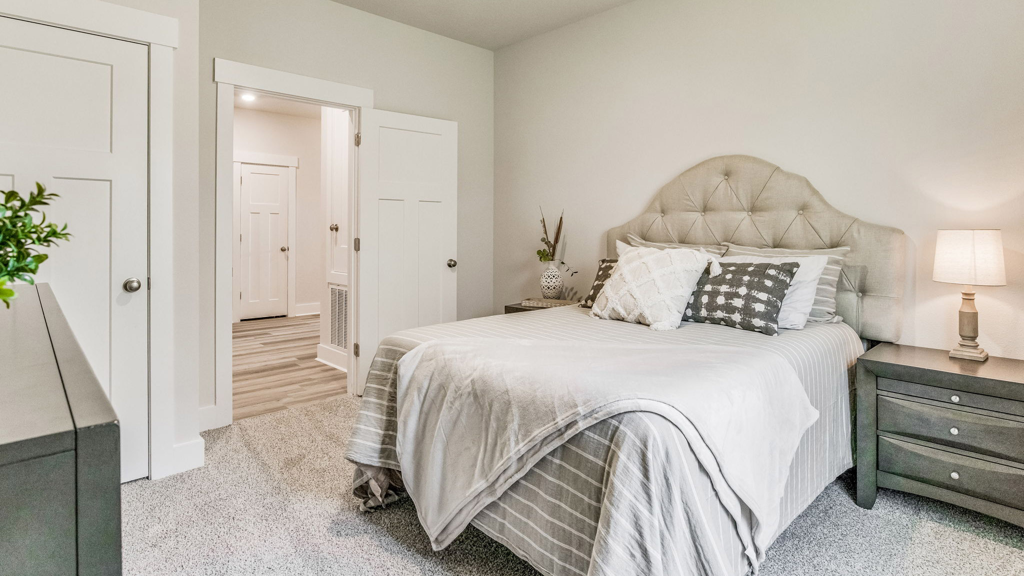 The Rhett floorplan guest bedroom one with carpet throughout