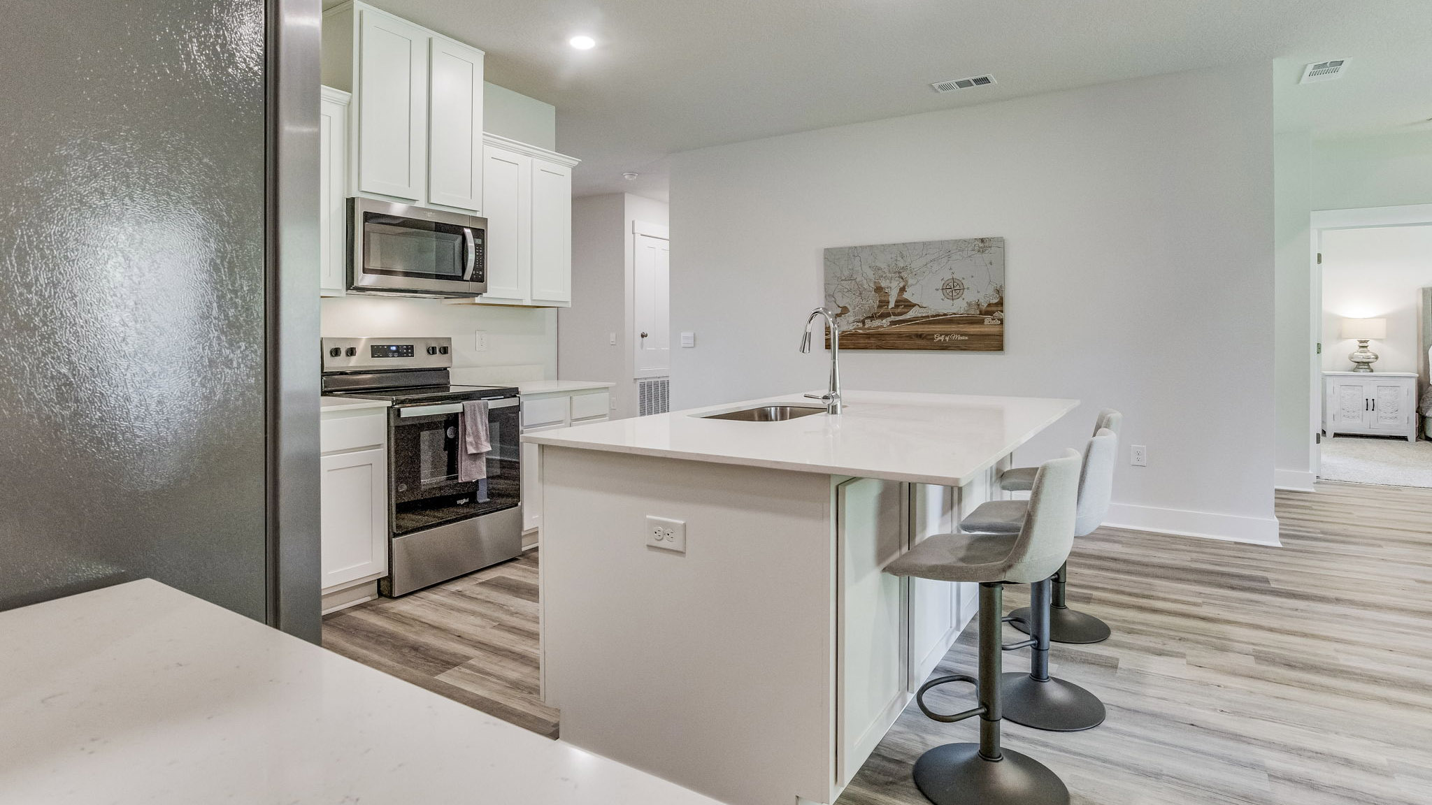 The Rhett floorplan kitchen island with quartz countertops and stainless-steel dishwasher