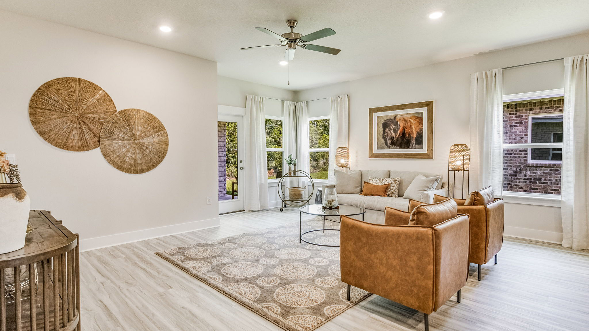 The Riverside floorplan open concept living room with three windows