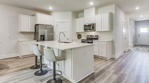 The Rhett floorplan kitchen with quartz countertops and white shaker cabinets