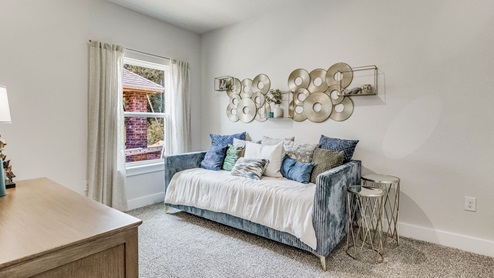 The Riverside floorplan guest bedroom two with carpet throughout