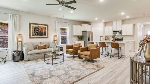 The Riverside floorplan open concept living room and kitchen with EVP flooring throughout