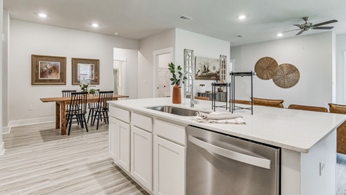 The Riverside floorplan kitchen island with quartz countertops and stainless-steel dishwasher