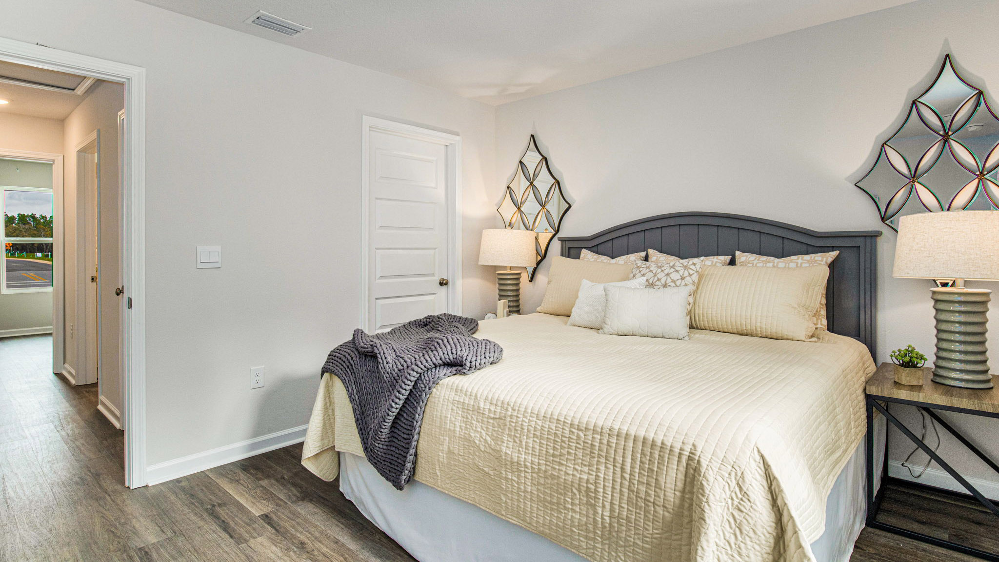 The Allanton floorplan primary bedroom with EVP flooring throughout