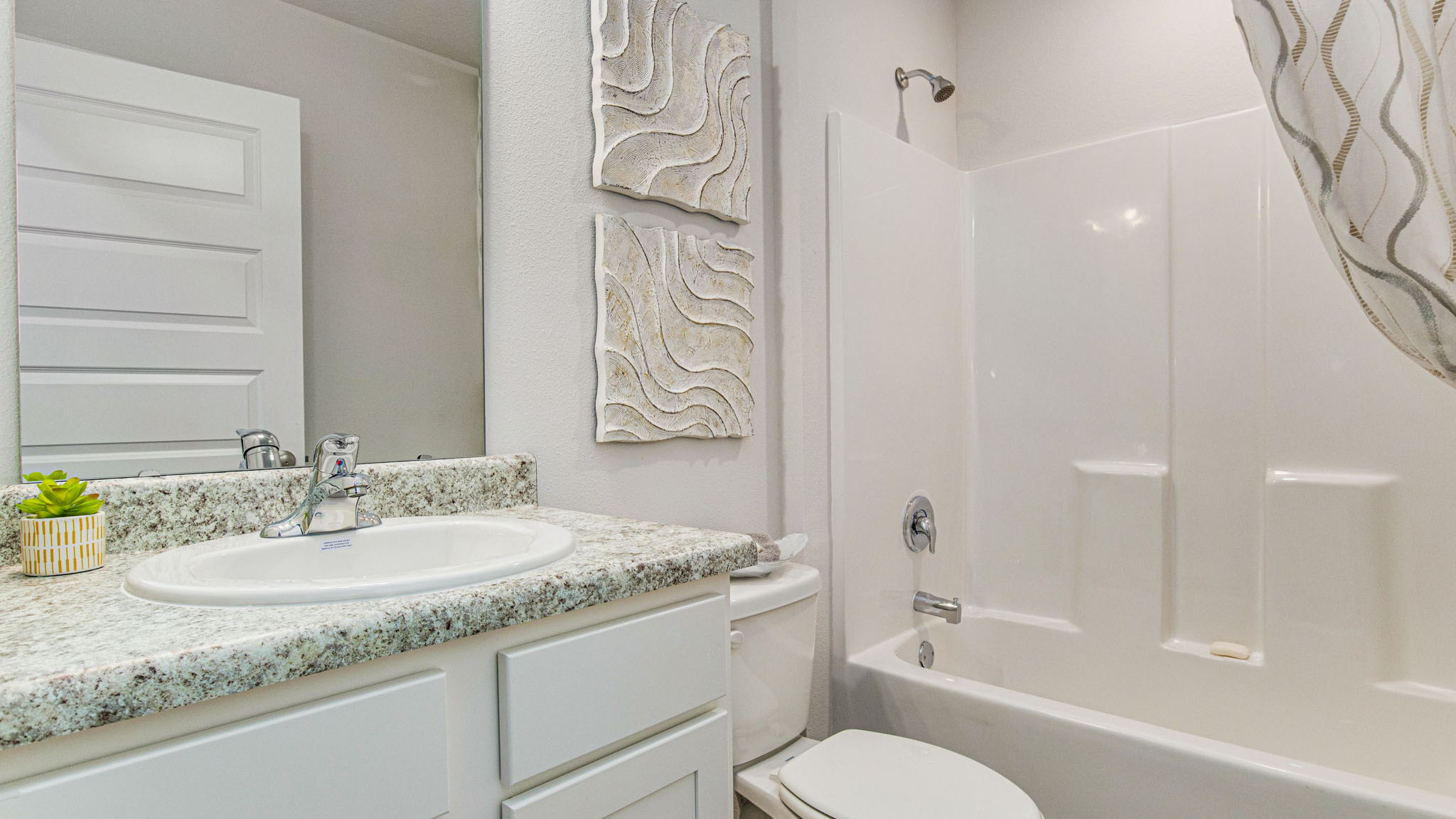 The Allanton bathroom with shower tub combo and single vanity